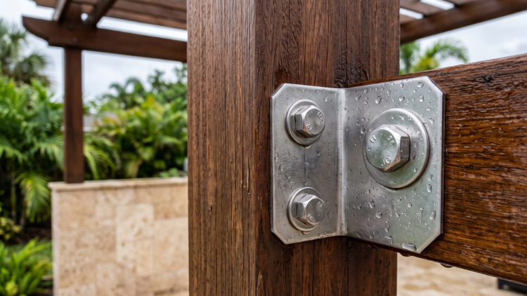Galvanized steel bracket securing a wood pergola post